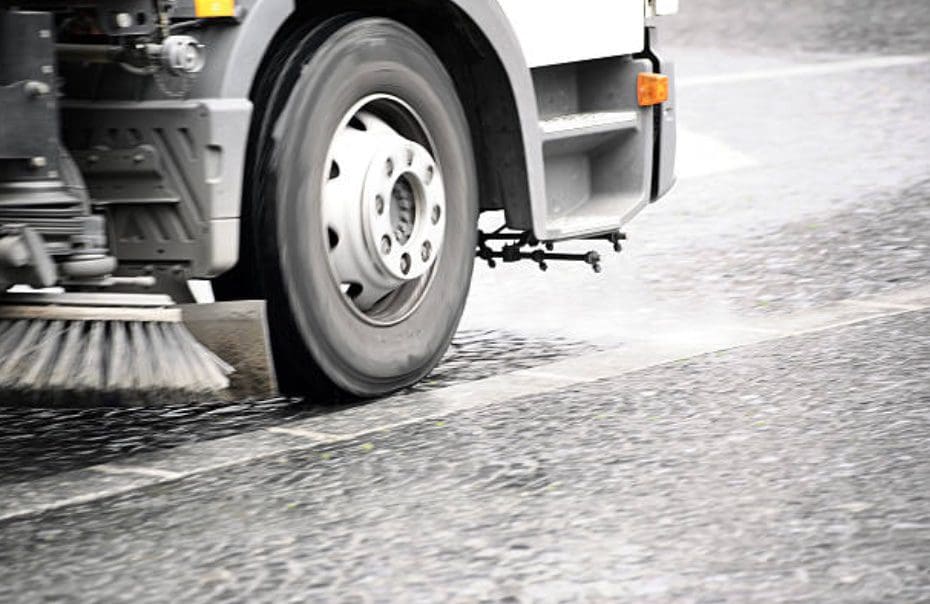 Side view of Sweeper on a Street Sweeping Truck