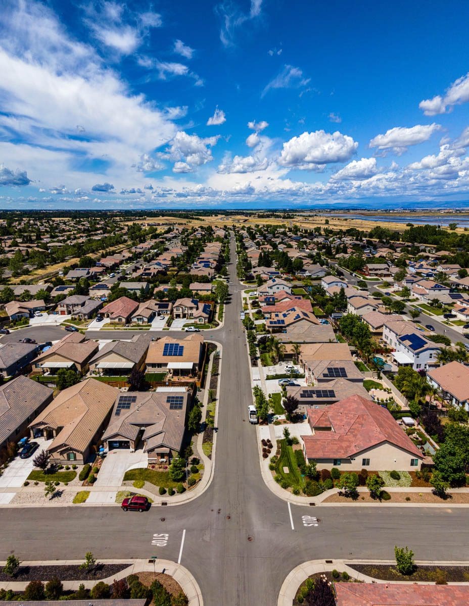 housing community with bright blue sky and clean swept streets