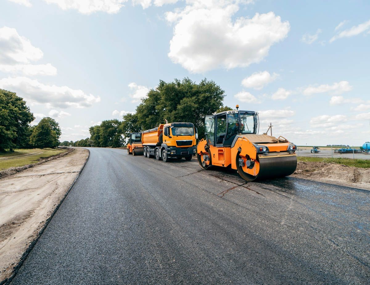 asphalt rollers driving down a cleanly sweeped street, Street Sweeping & Pressure Washing Services in Los Angeles County