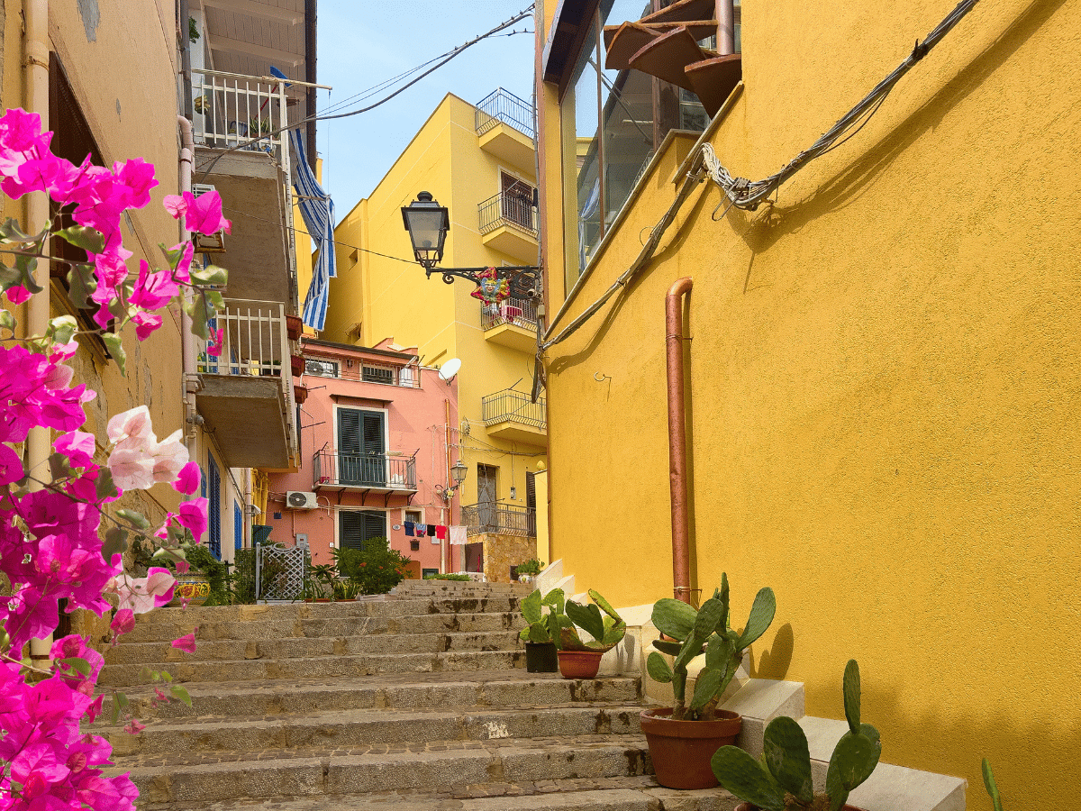 Colorful downtown street scene with stairways and Mediterranean-style buildings in Santa Paula, California.