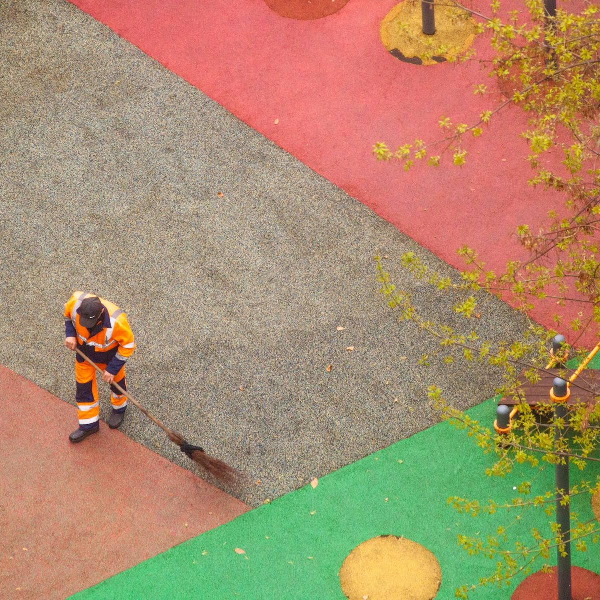 Street cleaning worker sweeping debris from a paved community area for HOA sweeping in Malibu, CA