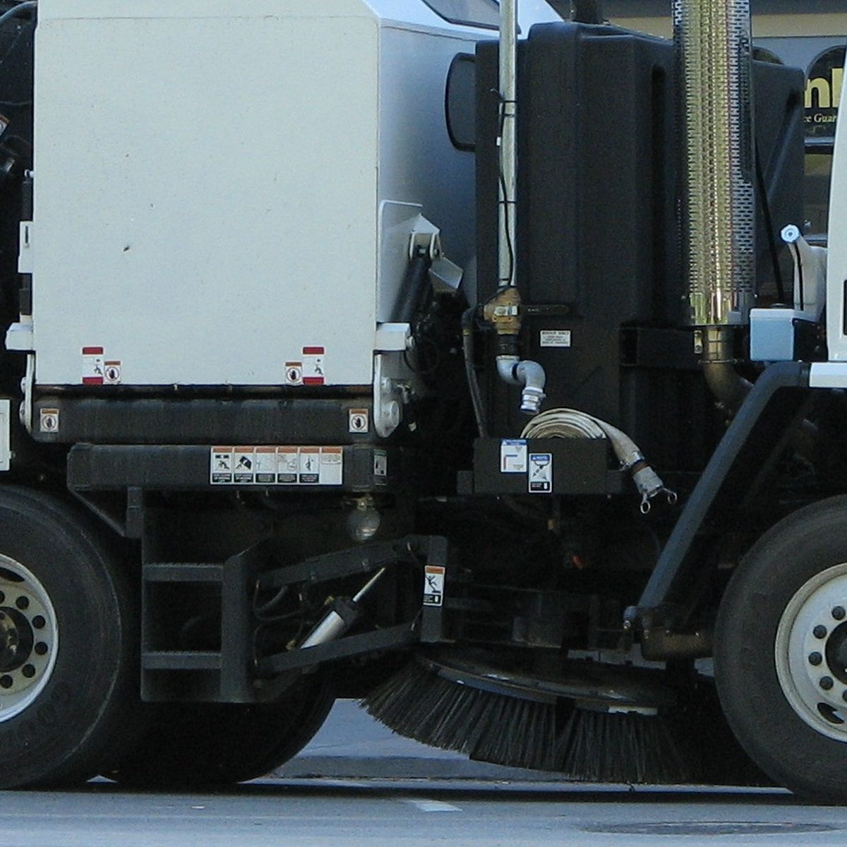 Municipal street sweeper truck with rotating brushes for street cleaning in Hollywood, CA
